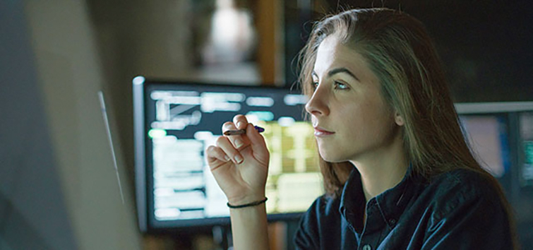 Computer engineering student working at a computer in a classroom